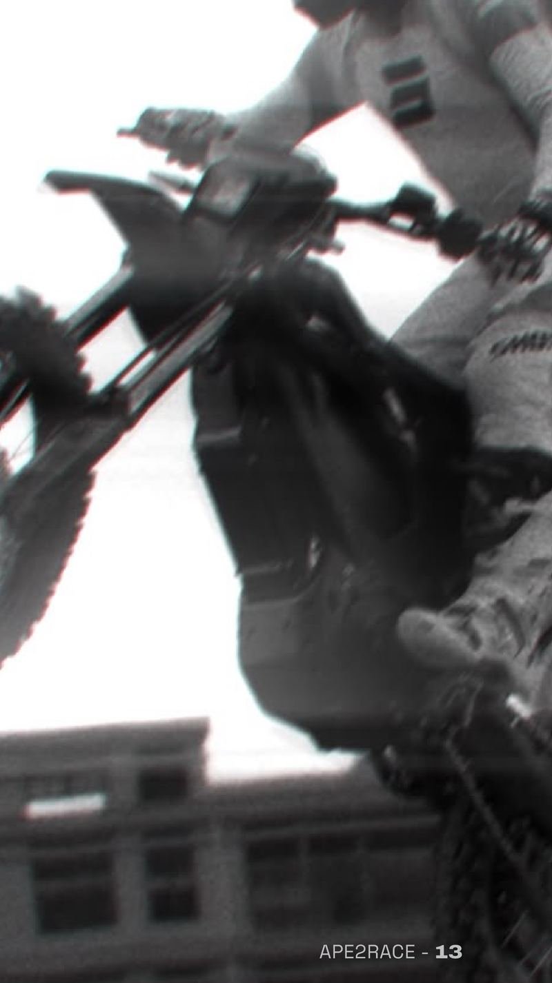 Black and white photo of a rider jumping an electric dirt bike